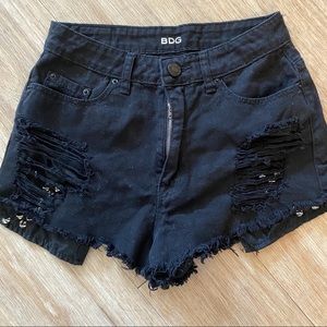 Studded and distressed black high waisted shorts.
